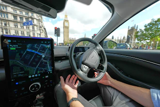 An Uber driver has his hands ready for intervention as he sits in an autonomous car in London, Tuesday, Sept. 1, 2026 as Uber officially launches the first hailable autonomous cabs in London.