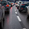 Heavy traffic congestion on a multi-lane highway with vehicles stopped bumper-to-bumper during rush hour.
