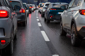 Heavy traffic congestion on a multi-lane highway with vehicles stopped bumper-to-bumper during rush hour.