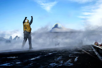 Person in yellow vest stands triumphantly on volcanic landscape with UFO and spacecraft visible in cloudy sky