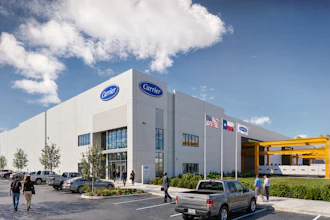 Modern Carrier HVAC dealership facility with white exterior, blue signage, and yellow equipment canopy under blue sky