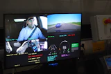 Multi-camera dashcam display showing driver, road view, and vehicle telemetry data with speed and performance metrics