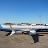 Boeing 737 commercial aircraft parked at airport with blue and white livery