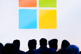 Microsoft logo featuring four colored squares in orange, green, blue, and yellow arranged in a grid pattern