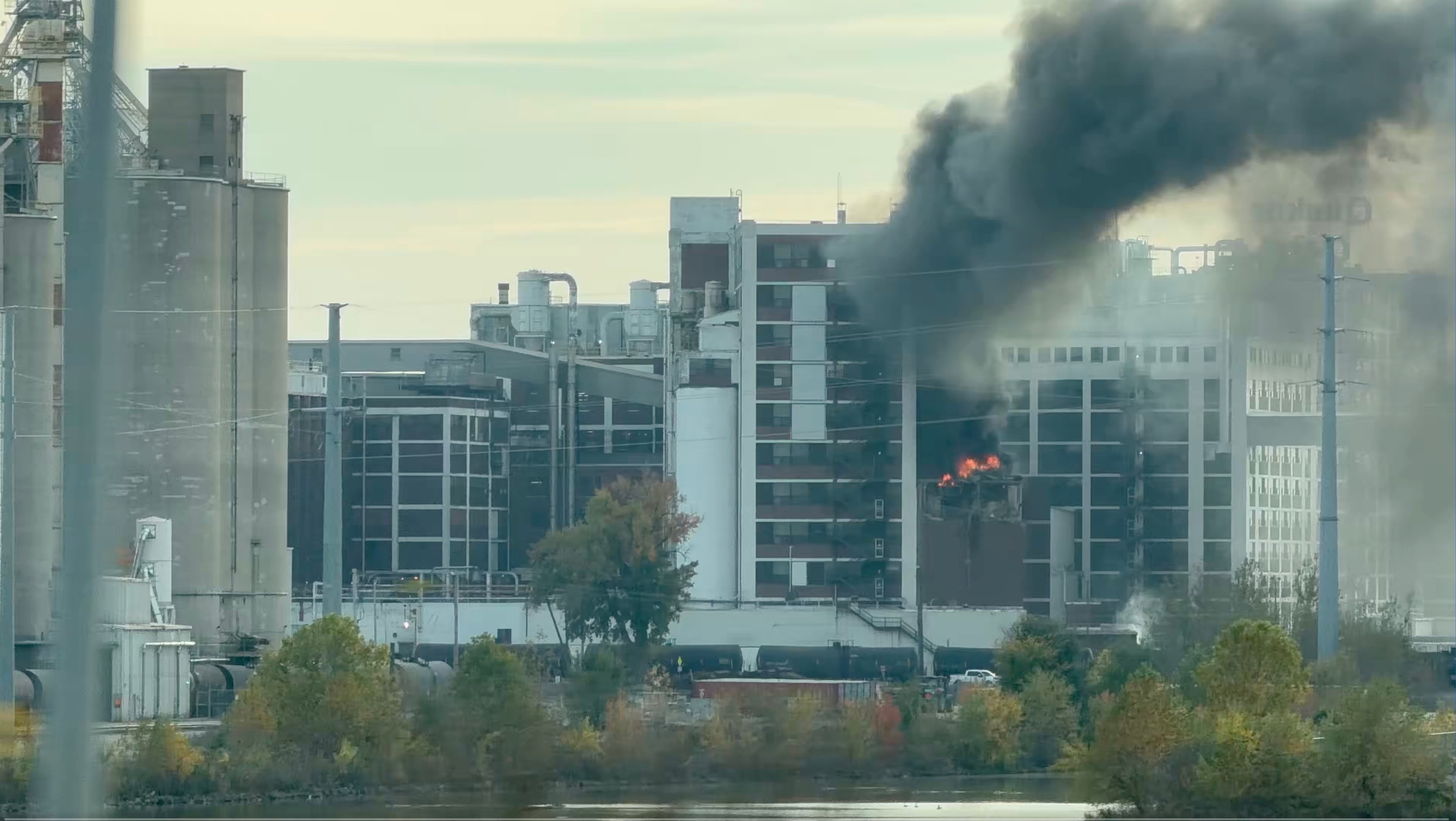 In this image from video, fire and smoke rise from a building attached to Quaker Oats facility in Cedar Rapids, Iowa.