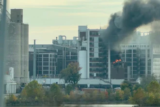 In this image from video, fire and smoke rise from a building attached to Quaker Oats facility in Cedar Rapids, Iowa.