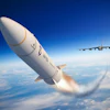 White rocket launching with flames against blue sky, military transport aircraft flying in background
