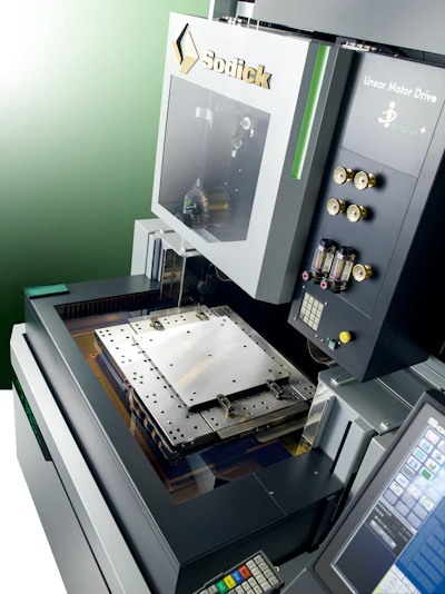 Smitek CNC precision manufacturing machine with linear motor drive control panel and metal workpiece on green background