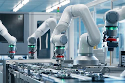 White collaborative robotic arms assembling electronic circuit boards in a modern manufacturing facility
