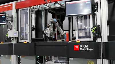 Bright Machines industrial robotic assembly system with red frame, articulated robot arm, and integrated control display