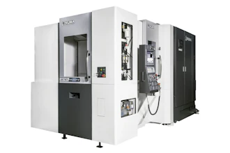 OKUMA CNC machining center with white and black exterior, doors open showing internal mechanical components and control panels