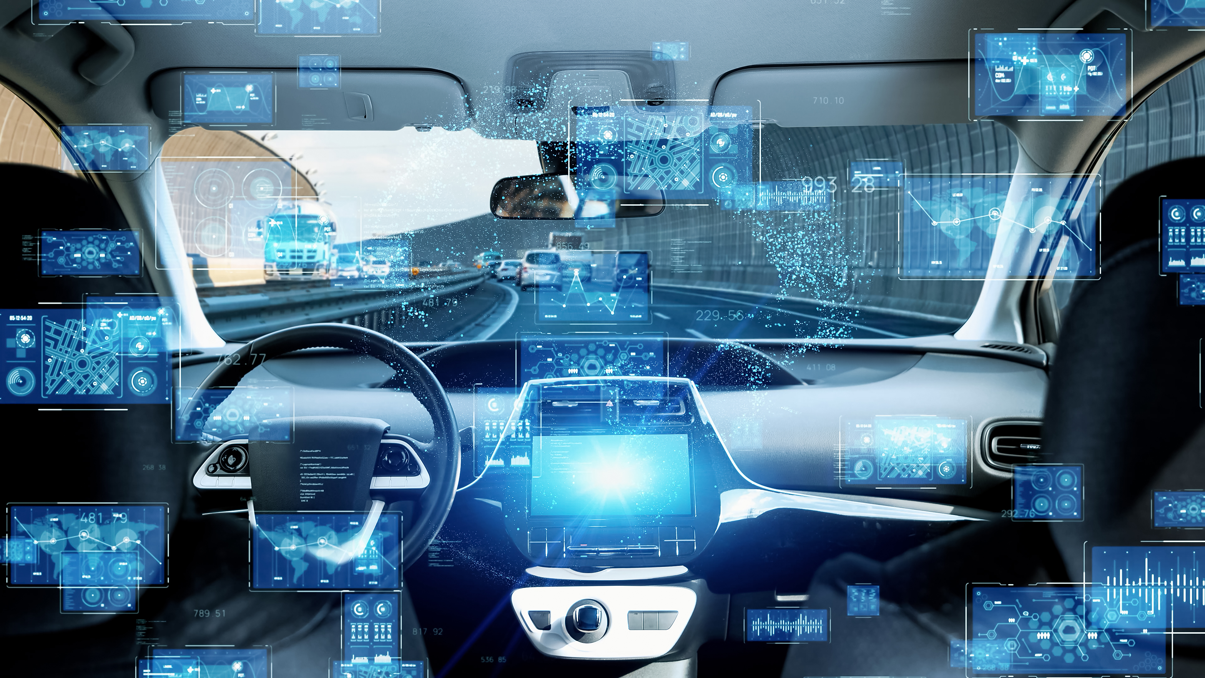 Futuristic car interior with digital dashboard displays and blue holographic interface elements representing autonomous vehicle technology