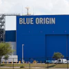 Blue Origin aerospace facility with large blue building facade displaying company name and launch tower