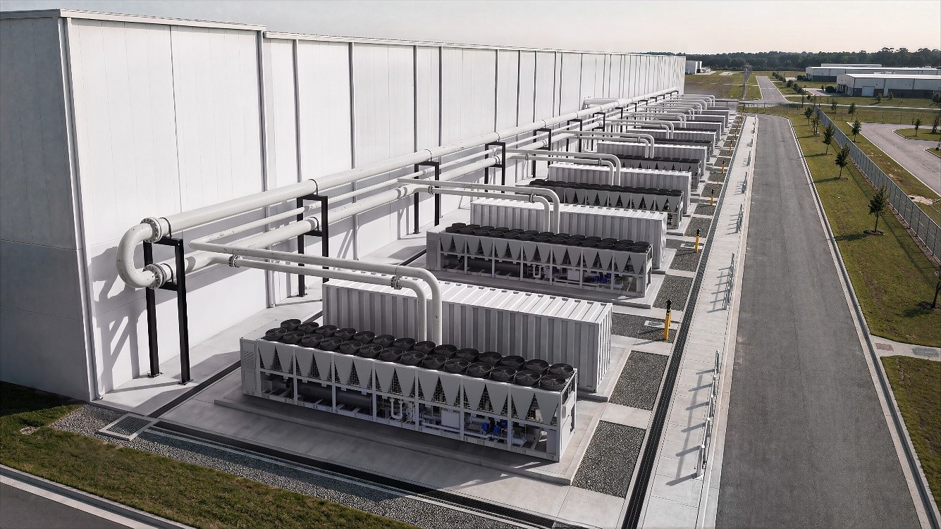 Industrial facility with rows of large rectangular structures under white roof framework and connecting piping systems