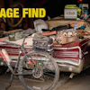 Garage find collection featuring red bicycle, car door panel, tools, and Arai helmet box on workbench