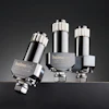 Three metallic Helmolux industrial pressure cartridge vessels with silver and black finishes displayed against dark background