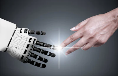 Human hand reaching toward robotic hand in a gesture of connection and collaboration against a gray background with light rays