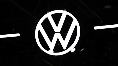 Volkswagen logo emblem illuminated against dark background