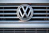 Volkswagen logo on wet vehicle grille with chrome trim